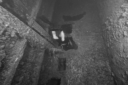 3/6/2023<br>But the divemaster, having seen us dive for several dives now, signaled to see if we wanted to go inside the ship?  We said yes, or Ryan (pictured) and I did, while Fred declined.   I just posted pretty much all the shots I took inside the ship on this trip, just so you can get a better idea of what it was like.   Almost all of the shots were taken with the camera level, very often with the diver in front of me visible as I followed in the rear.